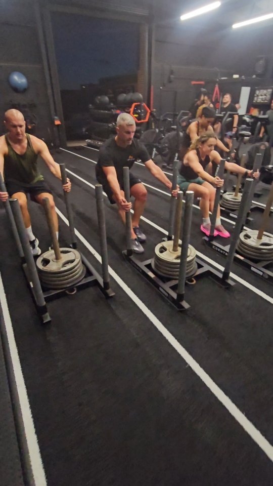 Members on the sleds during a METCON class at iAMDEFiANCE